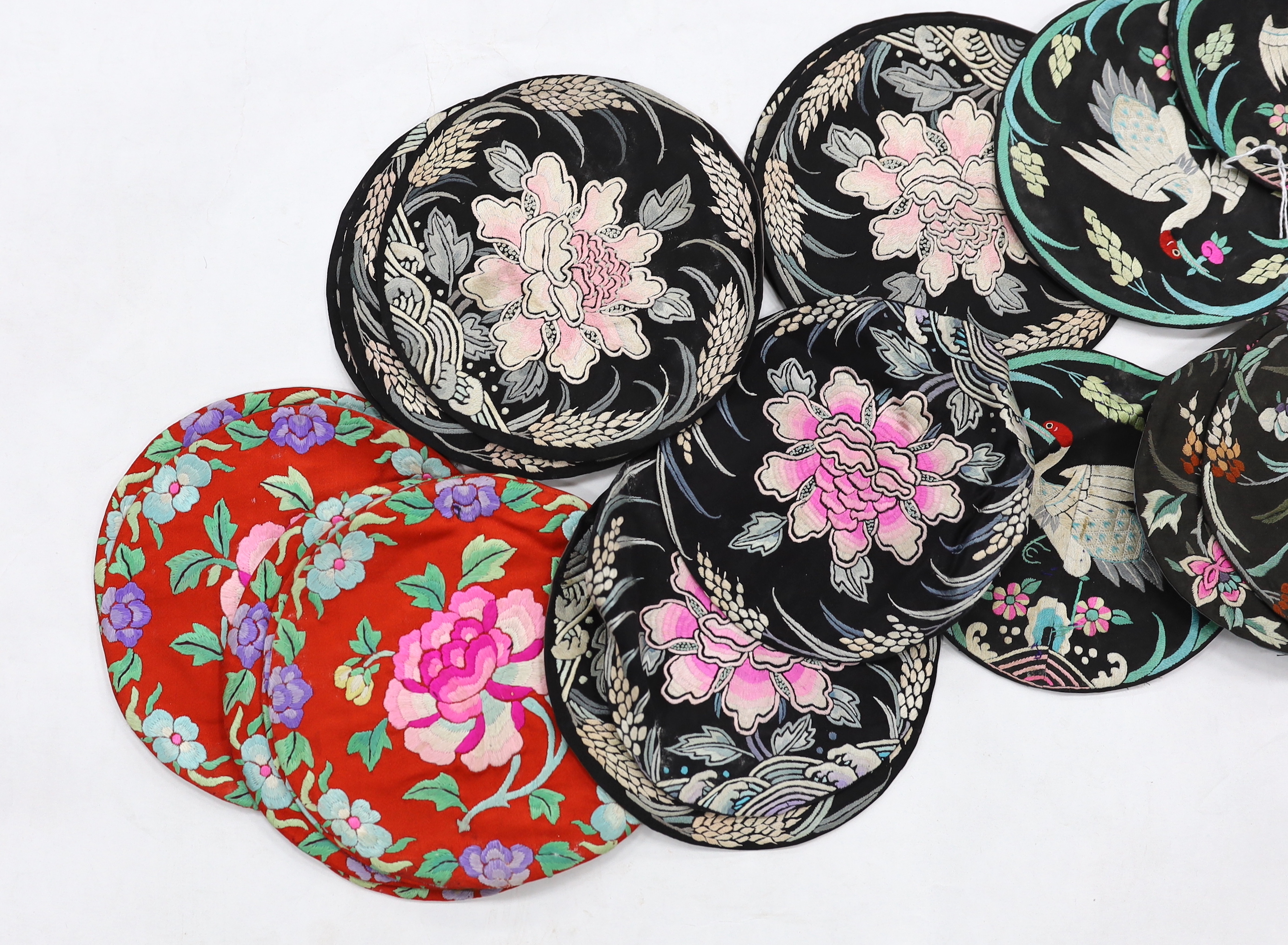 Four sets of eight circular Chinese silk embroidered mats and a set of three similar mats, all depicting birds and stylistic flowers